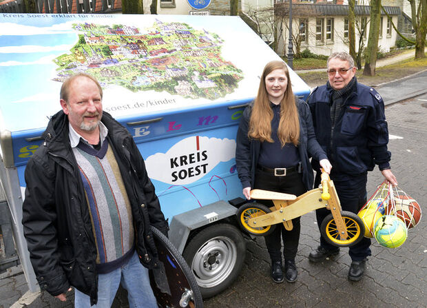 Feuerwehrfrau und Erzieherin Doreen Schaefer sowie Gemeindebrandinspektor Georg Ptacek (von rechts) von der Freiwilligen Feuerwehr Wickede (Ruhr) haben das Spielmobil des Kreises Soest schon für eine Veranstaltung in Wickede abgeholt. Die Übergabe des mit Spielgeräten aller Art beladenen Pkw-Anhängers erfolgte durch Werner Müller (links) vom Fachberatungsteam Jugendbildung und Jugendförderung des Kreises Soest. FOTO: THOMAS WEINSTOCK / KREIS SOEST